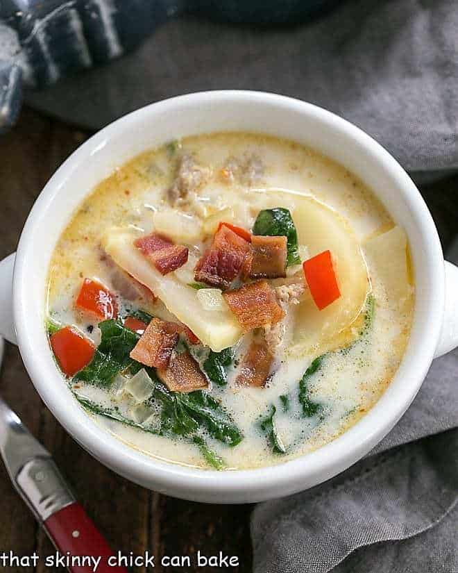 Zuppa Toscana or Tuscan Sausage Soup overhead view in a white soup bowl.