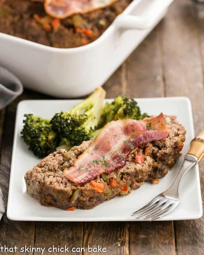 How to Make the Best Meatloaf plus bonus recipes and tips for a perfect meatloaf Slice of Boarding House Meatloaf on a square white plate.