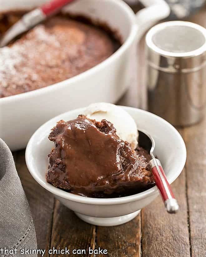 Easy Chocolate Pudding Cake in a bowl with a spoon and a scoop of ice cream