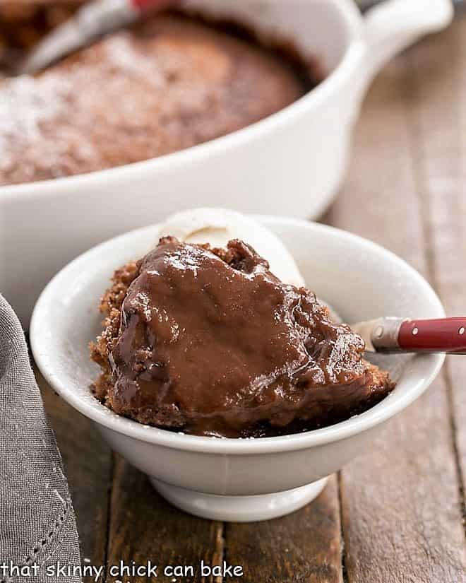 Easy Chocolate Pudding Cake in a white bowl with a red handled fork
