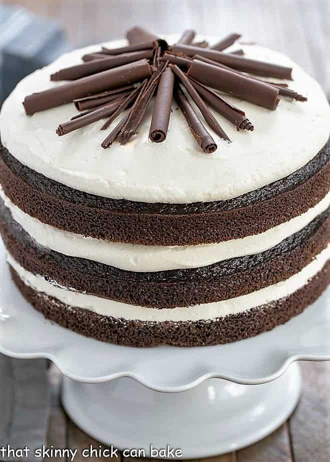 Triple Layer Chocolate Cake on a white ceramic cake stand