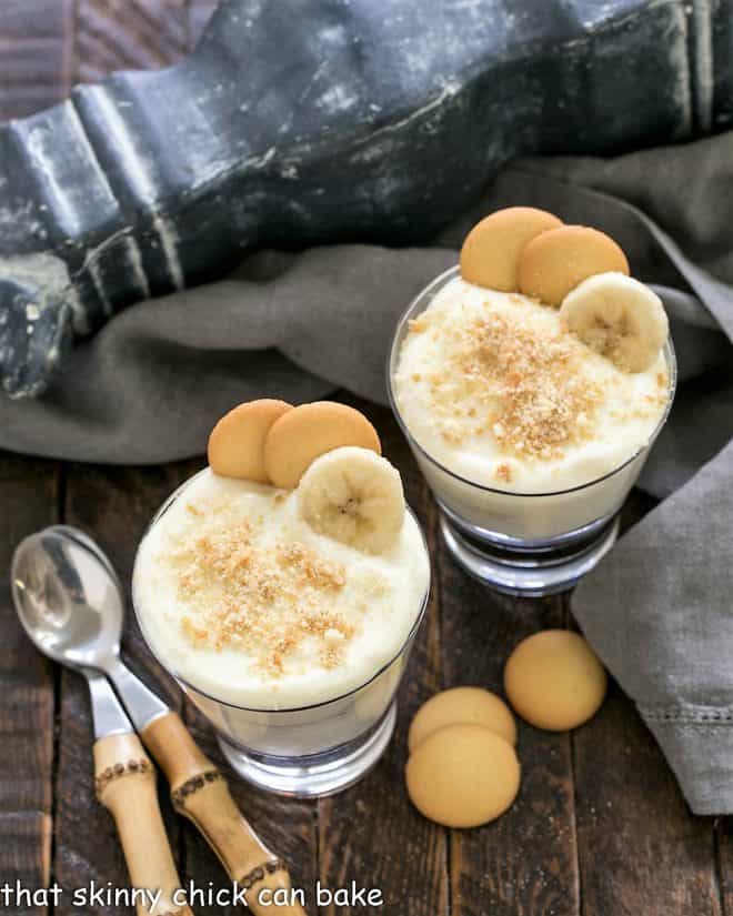 Overhead view of 2 banana pudding parfaits with spoons.