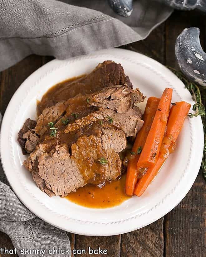 Overhead view of Braised Cola Brisket with Bourbon Gravy on a white plate.