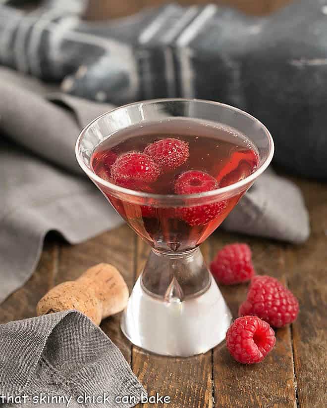 Classic Kir Royale with Cassis in a champagne glass with raspberries