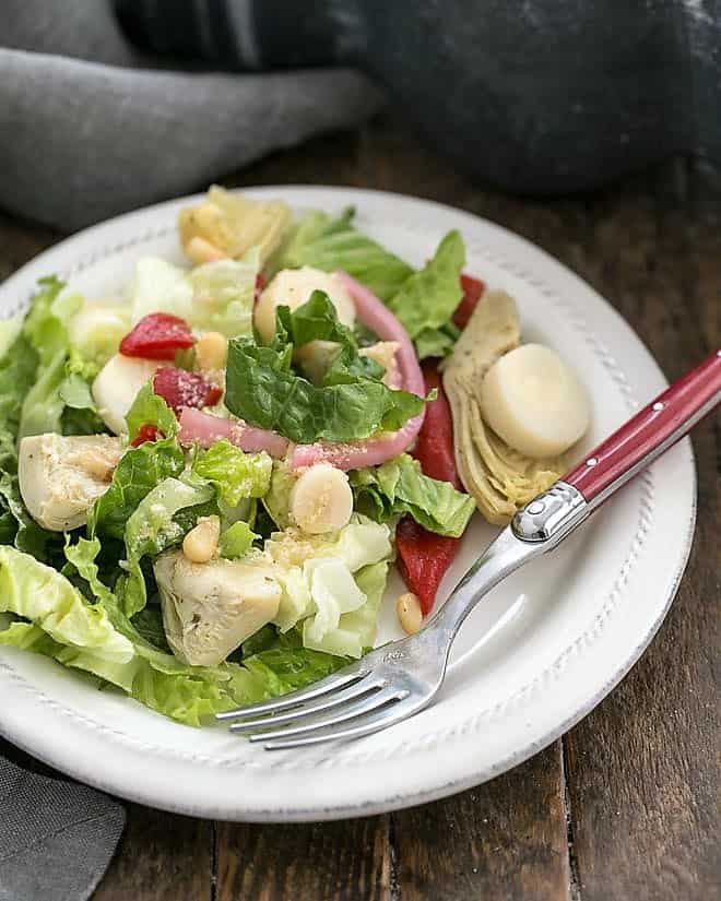 Italian Chopped Salad on a white salad plate with a red handled fork.