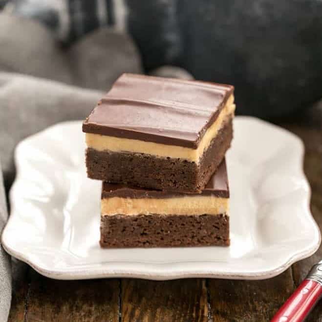 Stack of Peanut Butter Truffle Brownies on a white dessert plate.