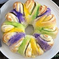 Easy King Cake with cream cheese filling on a round white serving dish viewed from above