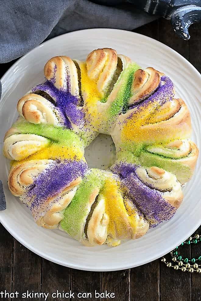 Easy King Cake with cream cheese filling on a round white serving dish viewed from above.