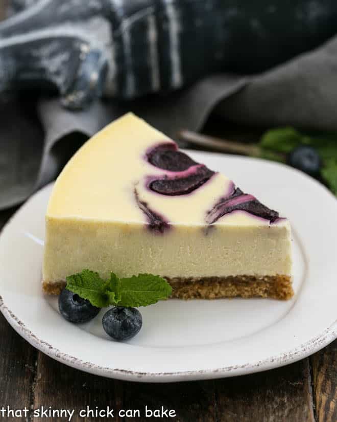 Blueberry Swirl Cheesecake slice on a white dessert plate