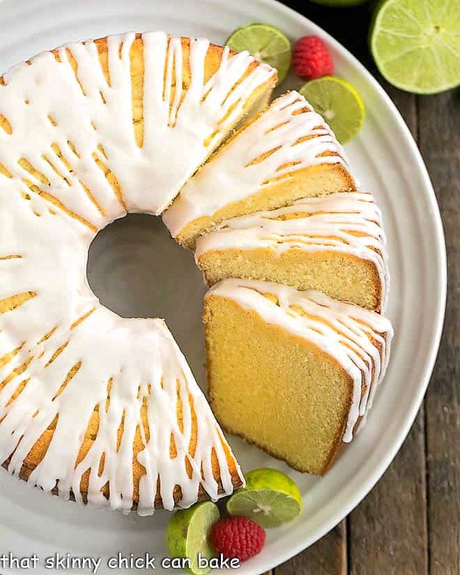 A sliced key lime pound cake on a white serving plate.