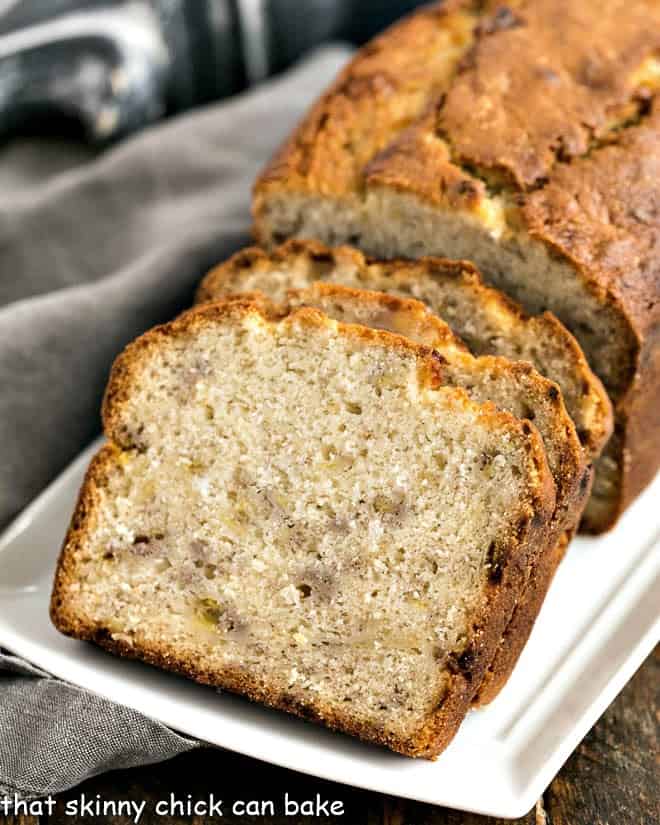 Buttermilk Banana Bread slices on a white ceramic tray.
