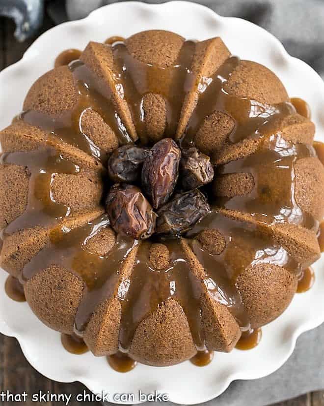 Caramel Topped Date Cake from above on a white cake stand