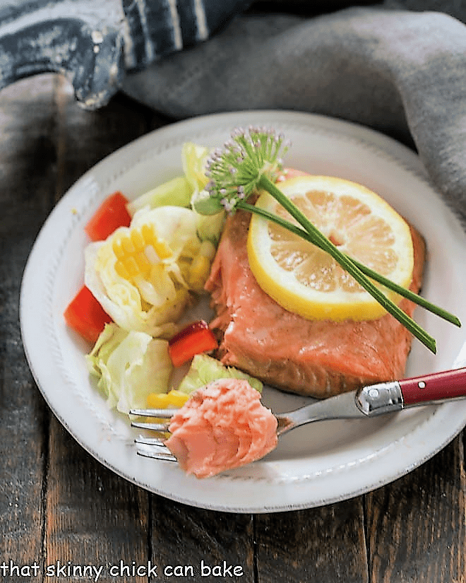 Easy Glazed Salmon on a white dinner plate with a fork holding a small piece of salmon