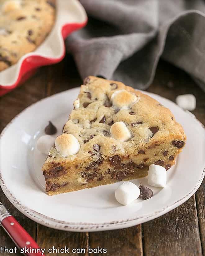 Slice of Gooey Chocolate Chip Pie on a white ceramic plate.