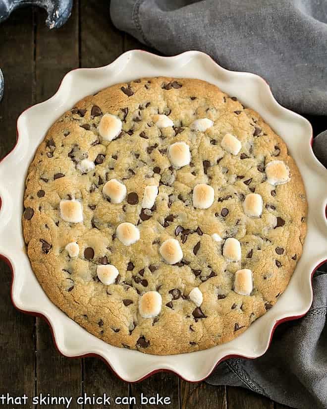 Gooey Chocolate Chip Pie in a red ceramic pie plate viewed from above.