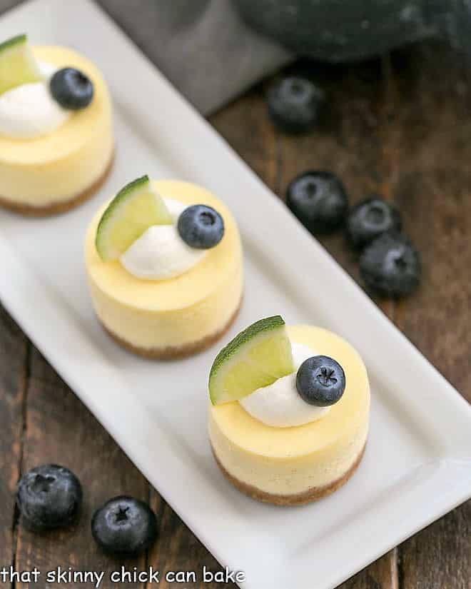 Mini Cheesecakes on a white rectangular tray viewed from above.