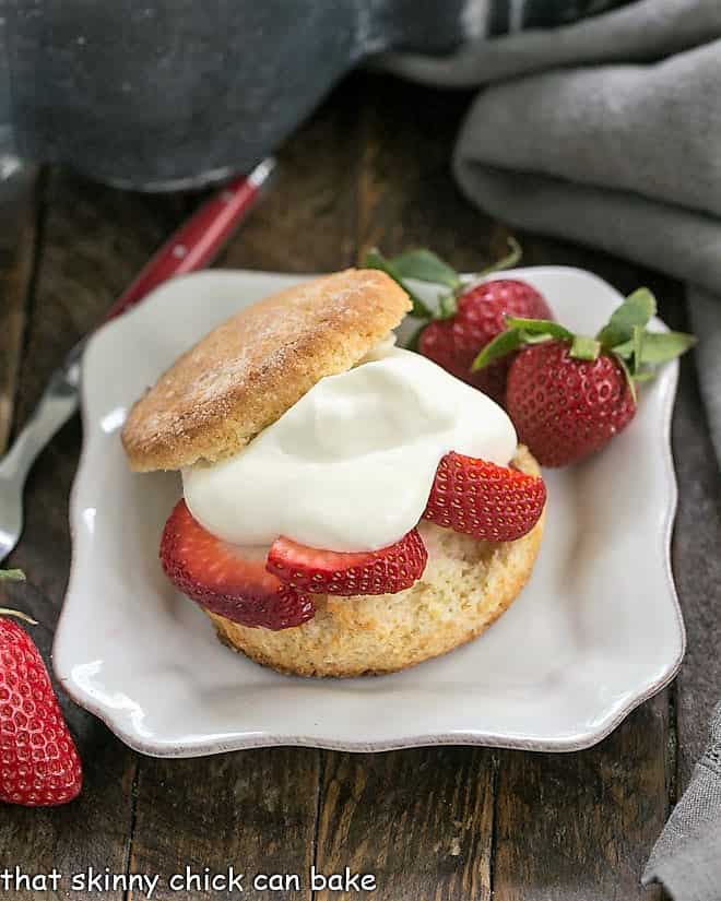 Strawberry Shortcakes with White Chocolate Whipped Cream on a square white plate.