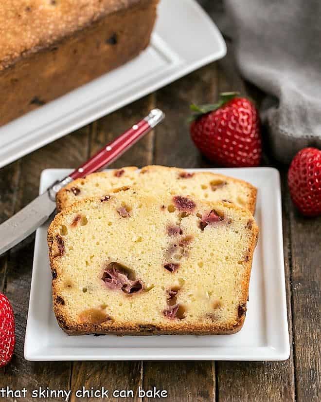  Fresh Strawberry Pound Cake slices on a square white ceramic plate with a red handled knife