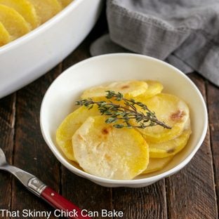small white bowl filled with the best scalloped potatoes recipe