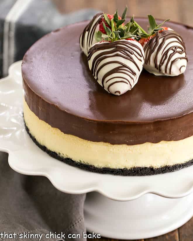 Ganache Topped Cheesecake with white chocolate covered strawberries.