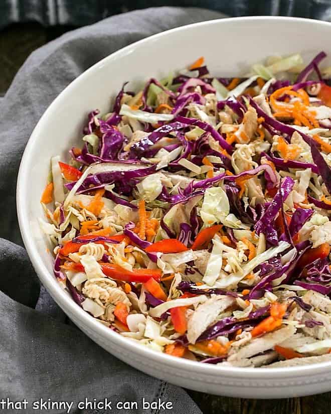 Asian Ramen Noodle Salad with Chicken in a white ceramic serving bowl.