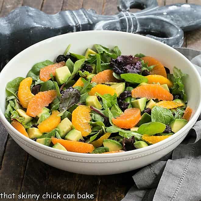 Cherry Orange Salad with Citrus Vinaigrette in a white ceramic serving bowl.