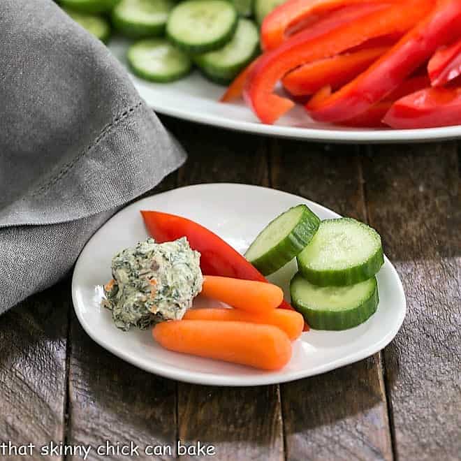 Sour Cream Spinach Dip on a small white plate with crudite