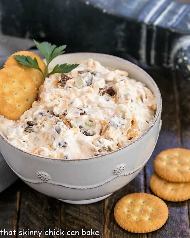 Bacon Cheddar Dip in a white bowl with butter crackers