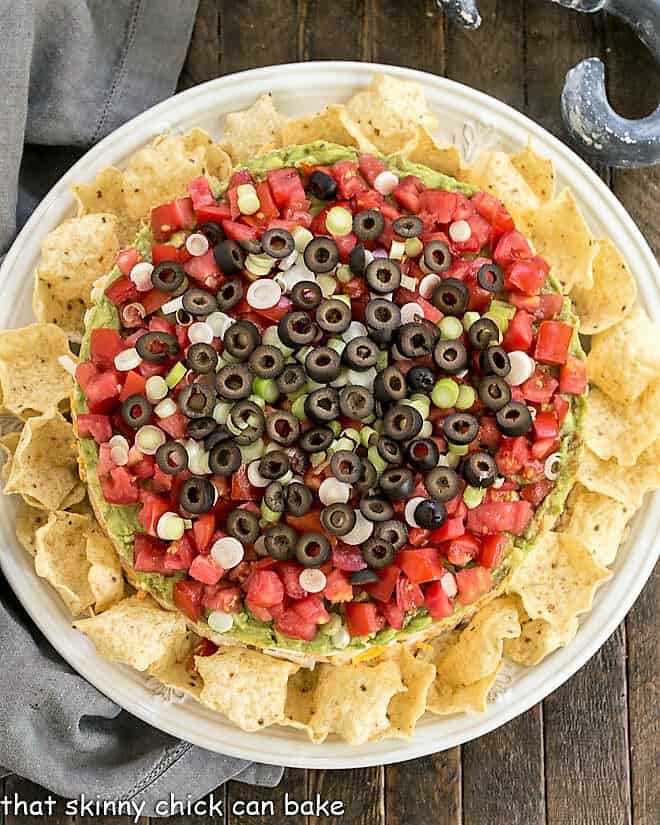 Overhead view of Layered Taco Dip surrounded by tortilla chips.