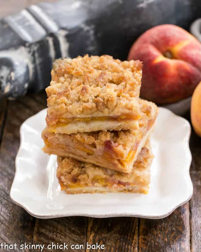 3 Fresh peach bars stacked on a square white plate