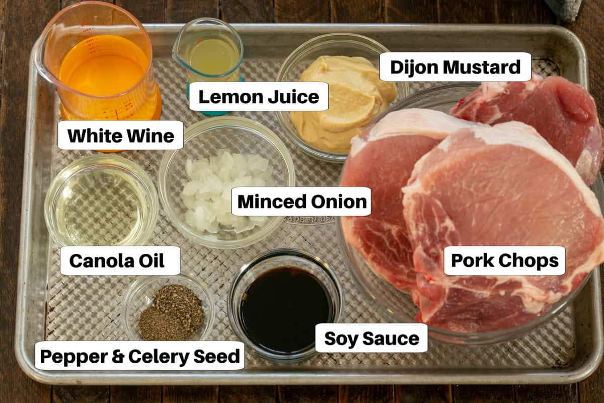 Marinated Pork Chops ingredients with labels on a sheet pan.