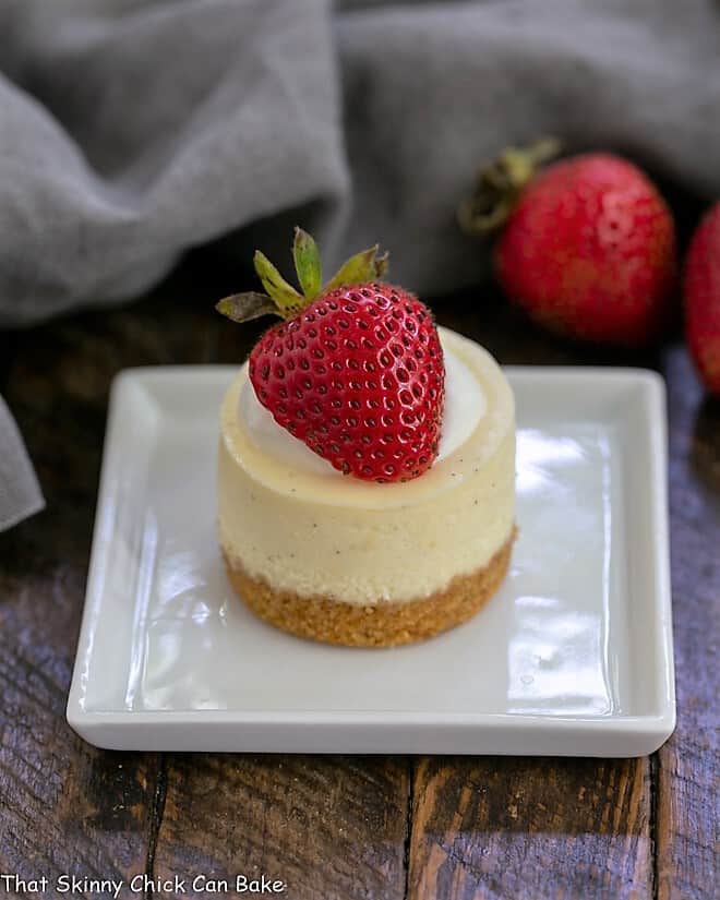 Mini Vanilla Bean Cheesecake on a small square white plate.