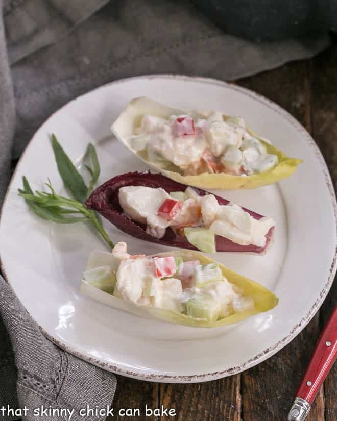 Overhead view of 3 Lobster Salad in Endive Cups on a white plate