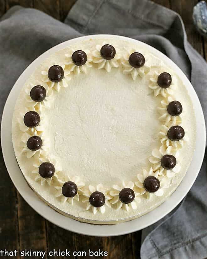 Overhead view of Tiramisu Cheesecake on a white cake stand.