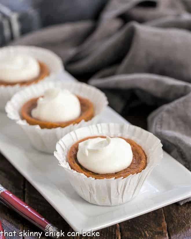 Pumpkin PIe cupcakes lined up on a white tray.