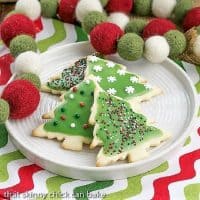 Frosted Holiday Sugar cookies on a round white plate