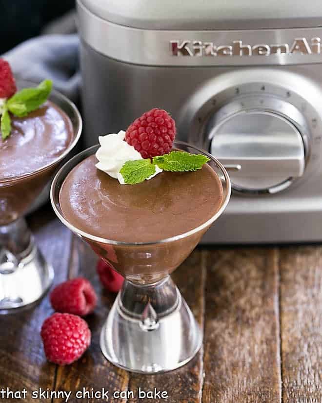 Blender Chocolate Mousse in a martini glass with whipped cream and raspberries.