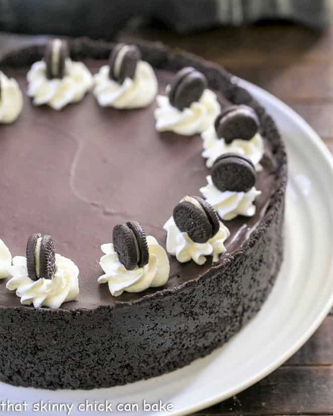 Partial view of a No Bake Oreo Cheesecake on a white serving plate.