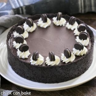 No Bake Oreo Cheesecake on a white serving plate garnished with cream roses and mini Oreos