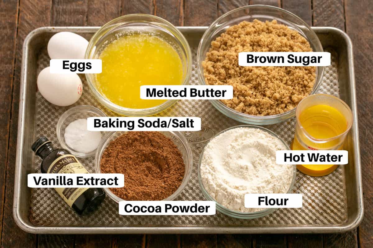 Fudge cake ingredients on a sheetpan with labels.