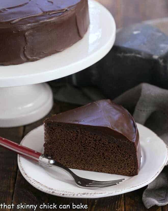 Slice of One Layer Fudge Cake on a white plate with a red handled fork.