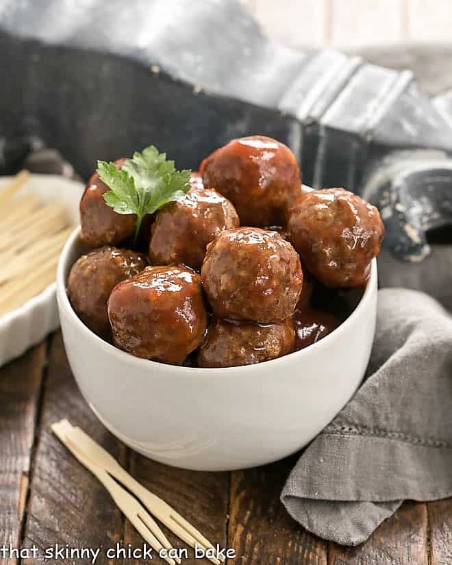 Cranberry Baked Meatballs in a white bowl with toothpicks