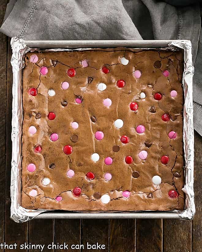 Overhead view of a square pan of the best brownies recipe with M & M's