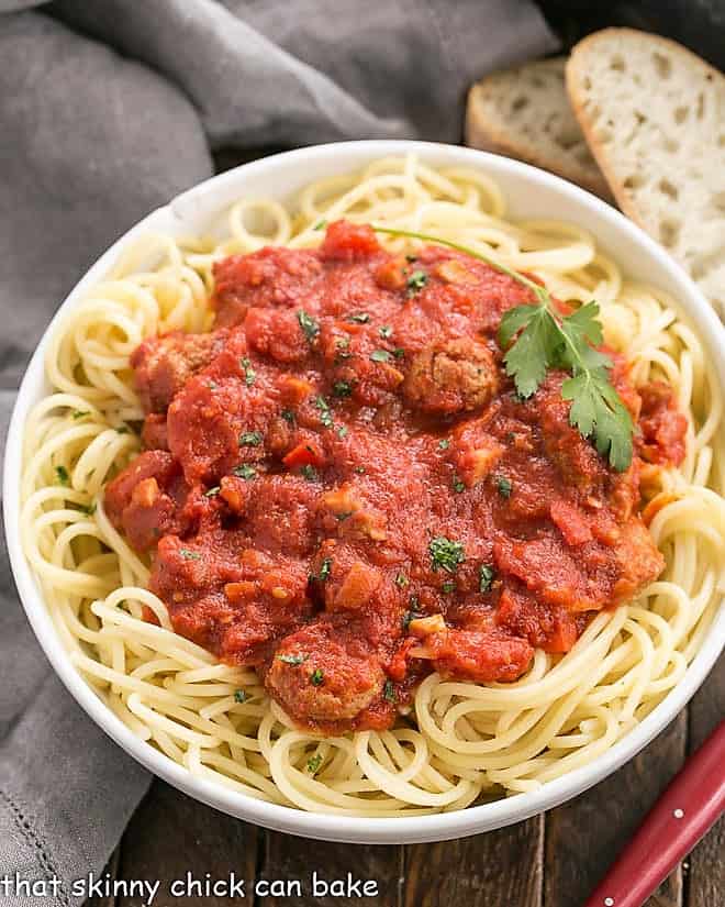 Overhead view of a homemade pasta sauce recipe over spaghetti