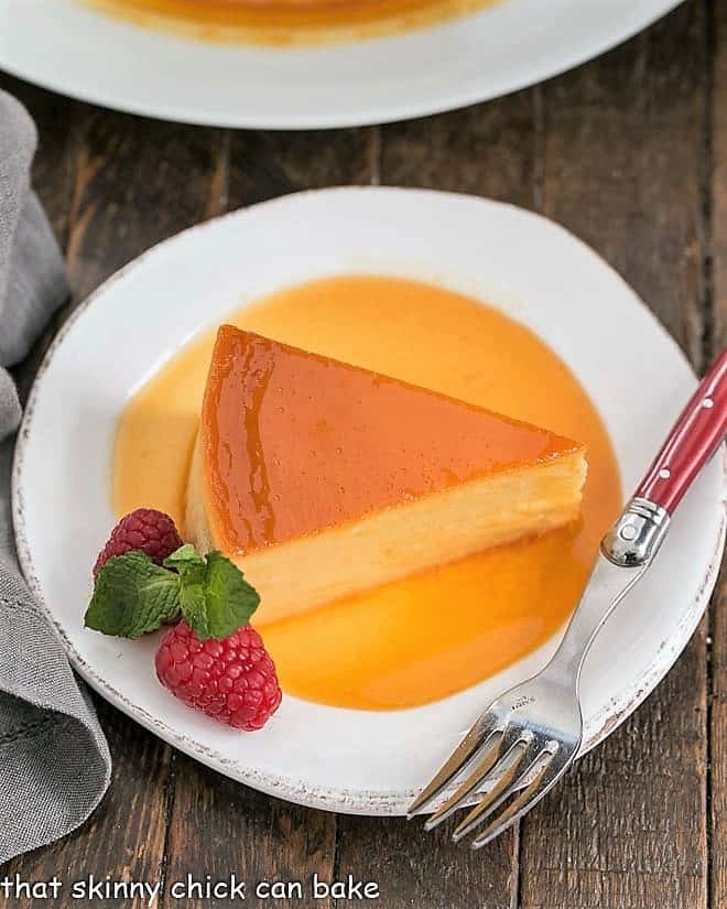 This rich and dreamy Cream Cheese Caramel Flan is a cross between creme brulee and cheesecake! Totally impossible to resist! Overhead view of Cream Cheese Caramel Flan Slice in caramel sauce.