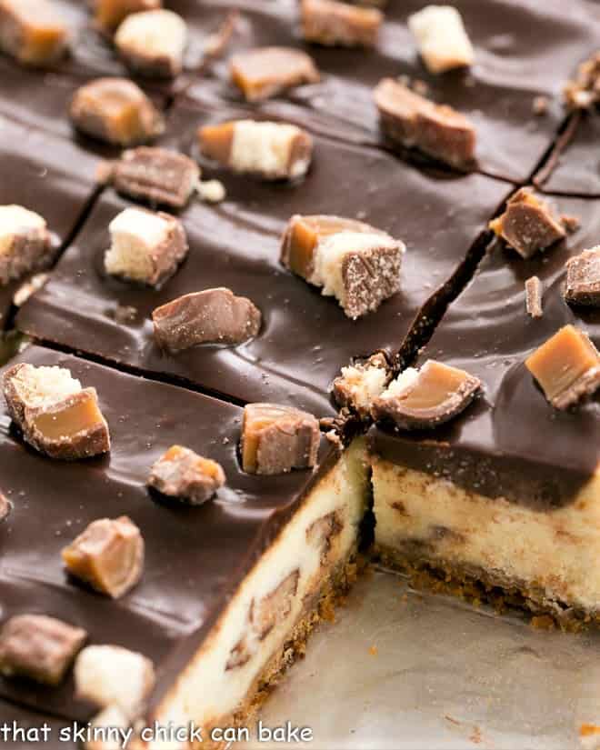Close up of pan of sliced twix cheesecake bars