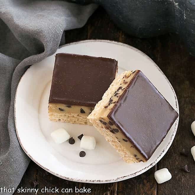 Two cookie dough rice krispie bars on a white plate