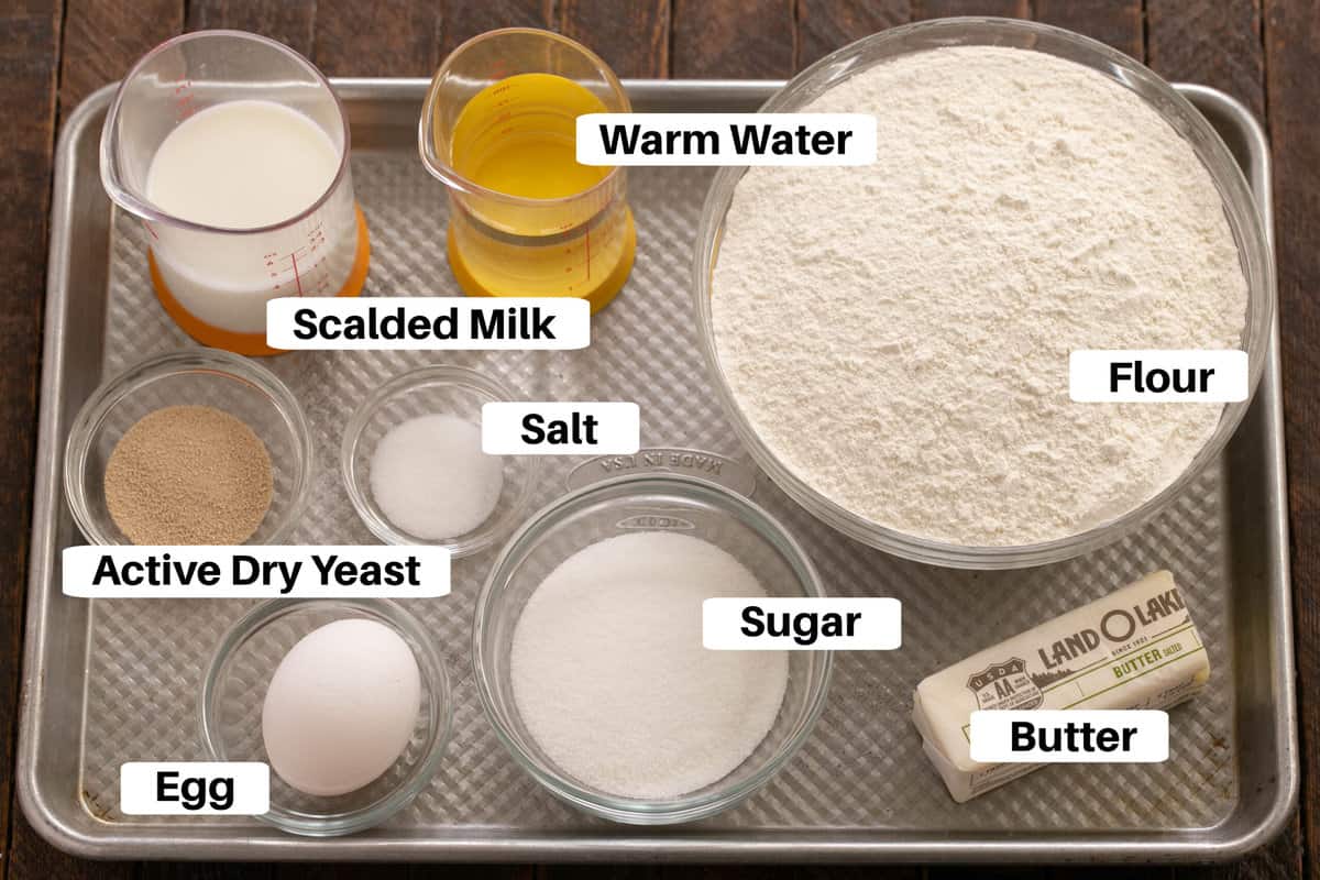 Orange Rolls Dough Ingredients with labels on a metal sheetpan.