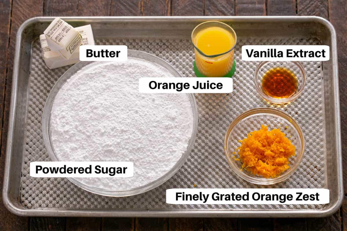 Orange Rolls Filling and Frosting Ingredients with labels on a sheet pan.