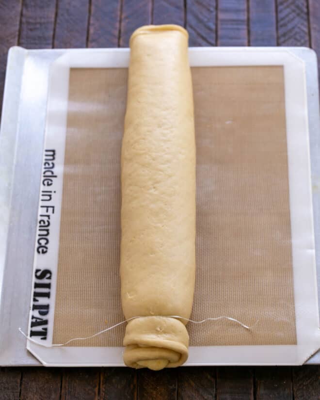 Dough cut into rolls with dental floss.